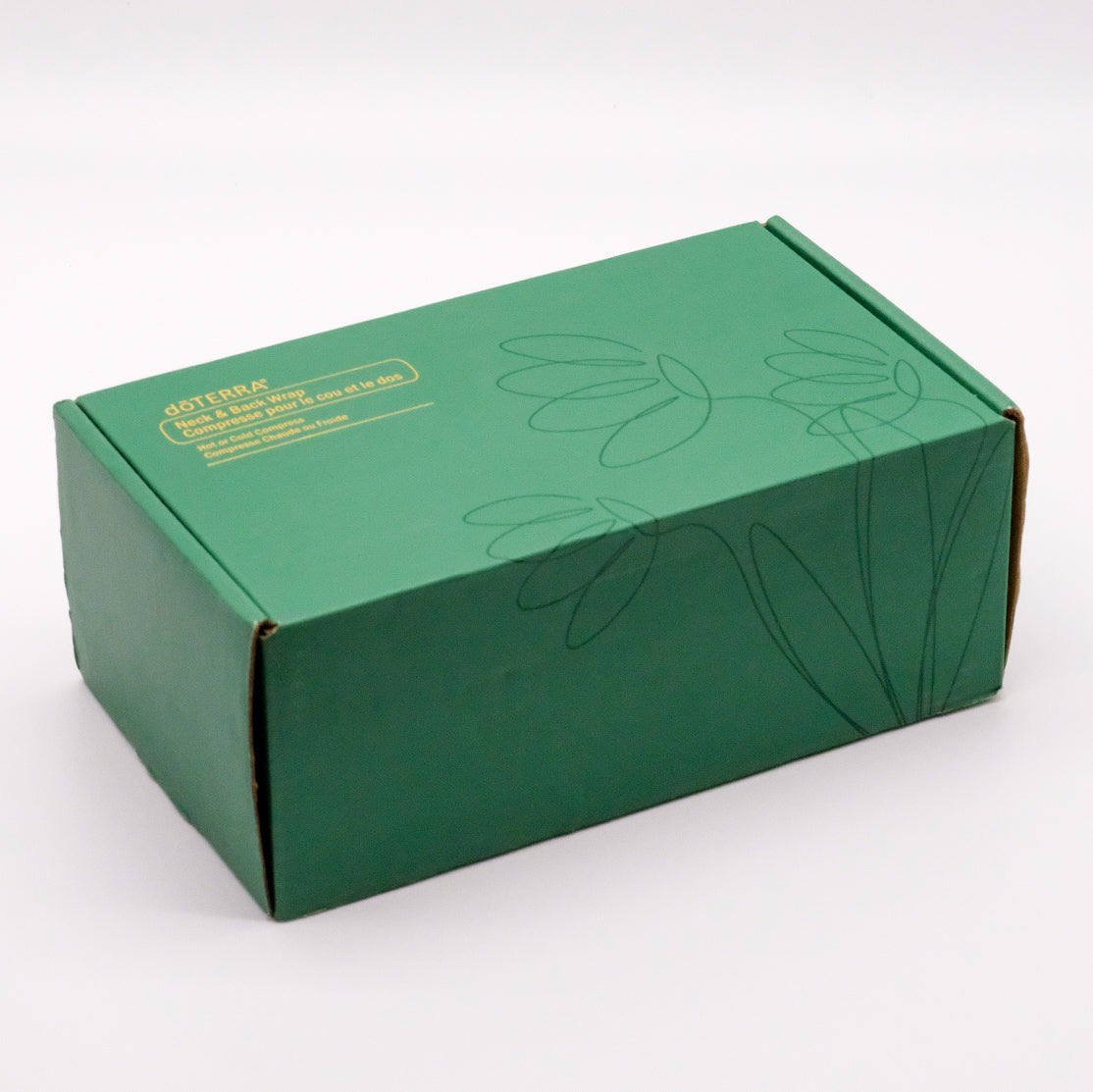 Boîte verte doTERRA du coussin thermique pour le cou et le dos, avec motif floral sur le couvercle.