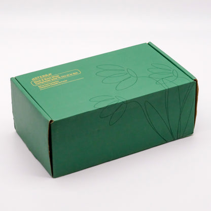 Boîte verte doTERRA du coussin thermique pour le cou et le dos, avec motif floral sur le couvercle.